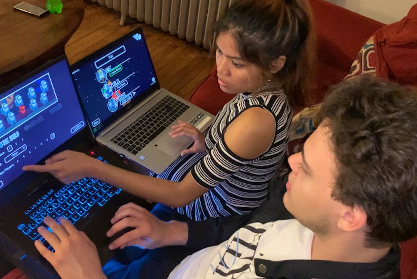 Kathleen Mendoza shows Daniel Oresanya how to create a new private room on the game Among Us. She says sharing tips and tricks is fun but risky if your friend is “the impostor”. 