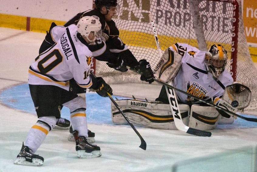Kyle Jessiman, right, of the Cape Breton Screaming Eagles makes a glove save while Ross MacDougall, left, and Adam Marsh, middle, battle during Quebec Major Junior Hockey League playoff action at the Eastlink Centre in Charlottetown on Saturday. The Charlottetown Islanders won the game 5-3.
