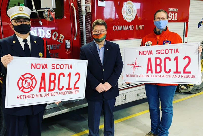 The provincial government will be providing specialty licence plates free of charge to retired volunteer firefighters and ground search and rescue members. Pictured here are, from left, Bob DeMont, president of the Windsor Fire Department Veterans’ Association, Hants West MLA Chuck Porter, and Marion Crosby, vice-president of West Hants Ground Search and Rescue. - Carole Morris-Underhill