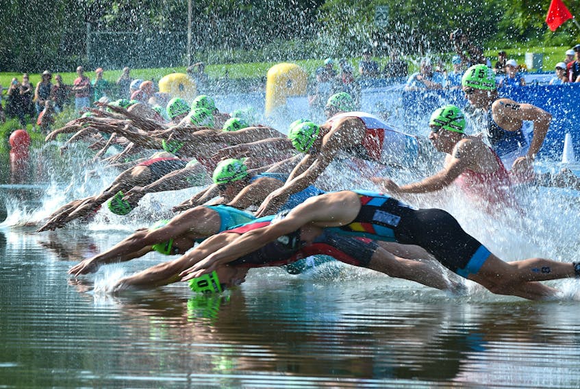 Competitors enter the water for the 750 metre course during the ITU World Triathlon at Hawrelak Park on July 20, 2019.