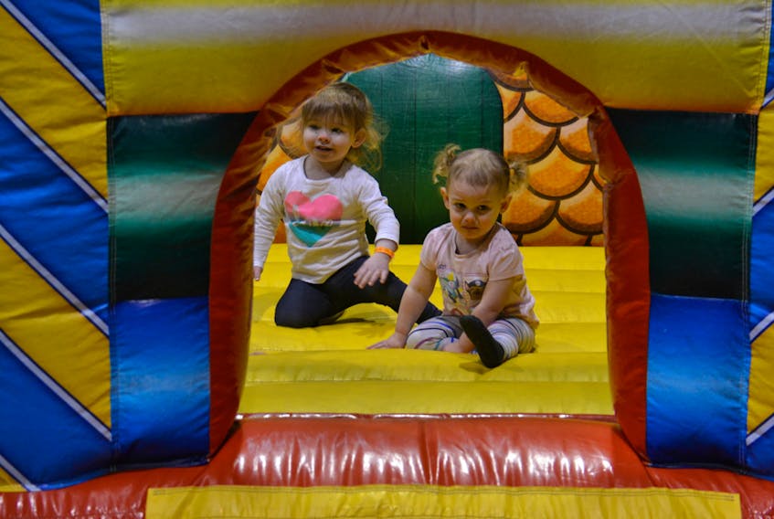 Elise Cormier, 2, of Antigonish, N.S., and Ayla Dewar, 1, of Charlottetown become new friends in one of the bouncy castles at the Eastlink Centre on Saturday during the Jack Frost Winterfest. KATIE SMITH/THE GUARDIAN