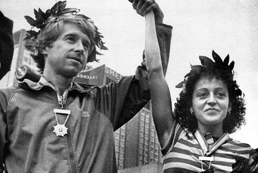 Jacqueline Gareau has her hand held high by Bill Rogers three weeks and two days after the Boston Marathon on April 21, 1980. Garneau was celebrated as first place woman after Rosie Ruiz was disqualified. Rogers was the winner of the men's division.  