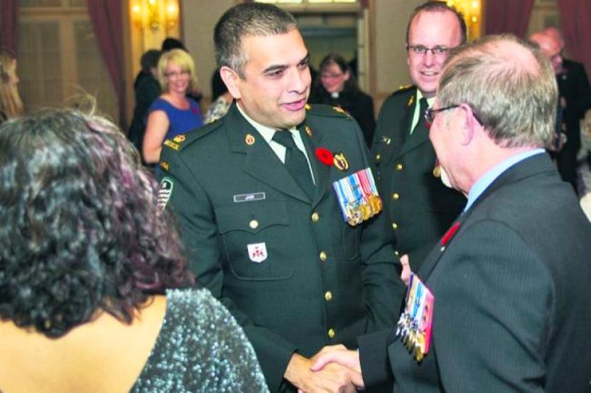 <p><span>Major Trevor Jain, left, and Chief Warrant Officer Michel Guay, right, congratulate each other after being honoured during the Mayor’s 11</span>th<span> Annual Veterans Recognition Awards at the Charlottetown Hotel Nov. 8 . Lt.–Col. Steven Wynne, centre, was also honoured during the ceremony.</span></p>