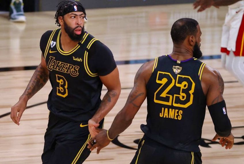 Lakers' Anthony Davis (left) reacts with teammate LeBron James during second half NBA Finals Game 2 action against the Heat at AdventHealth Arena at ESPN Wide World Of Sports Complex in Lake Buena Vista, Fla., Friday, Oct. 2, 2020.