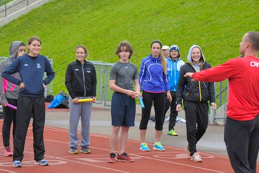 Olympic sprinter Jared Connaughton, right, speaks with Island track athletes during a clinic Wednesday in Charlottetown. <br /><br />