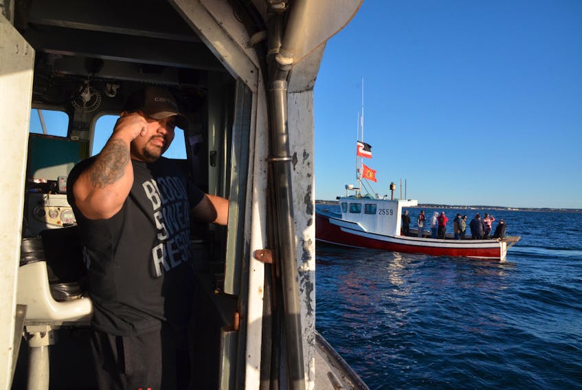 Terence Augustine aboard his vessel, The Lady Carol 1, looking for traps on Sunday evening that had been seized by commercial fisherment. (AARON BESWICK PHOTO)
