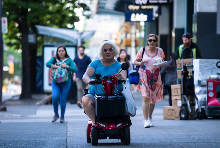 Jessica Yaniv, centre, arrives for a B.C. Human Rights Tribunal hearing in Vancouver, on Friday July 26, 2019.