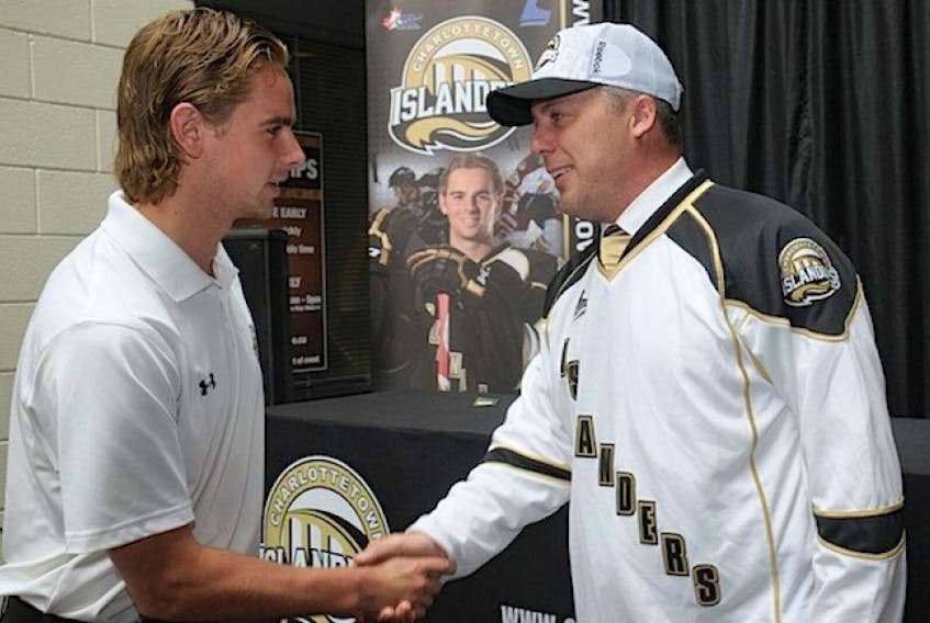 Charlottetown Islanders assistant captain Kameron Kielly, left, meets new head coach Jim Hulton following an introductory news conference Thursday at the Eastlink Centre.