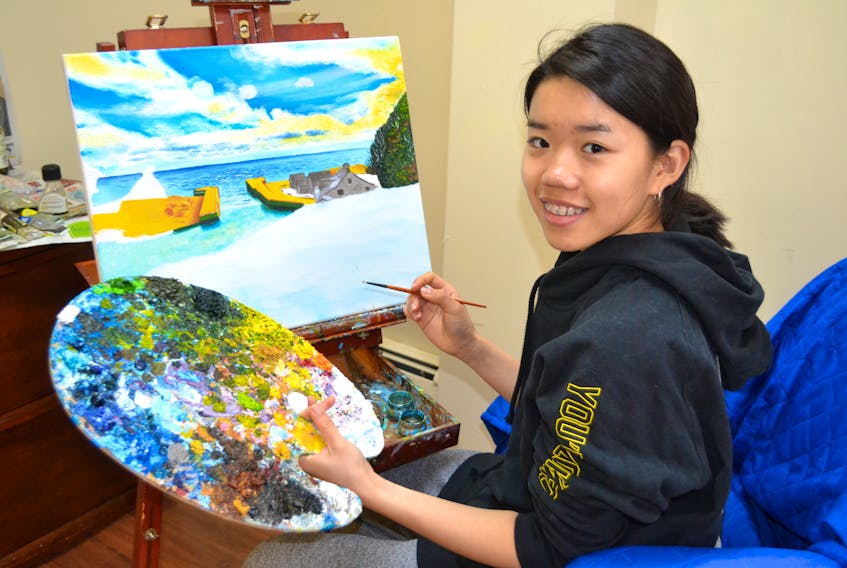 April Deng paints Sunset at Basin Head. It’s inspired by a photo of the provincial park. The 14-year-old hopes to visit the popular swimming site this summer. Sally Cole/The Guardian
