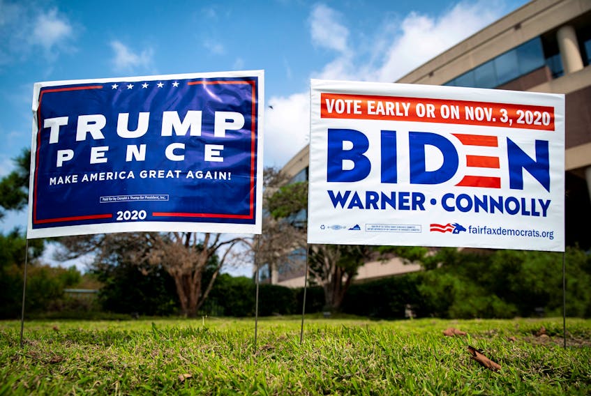Yard signs supporting U.S. President Donald Trump and Democratic presidential nominee Joe Biden are displayed in Fairfax, Virginia. REUTERS/Al Drago/File Photo
