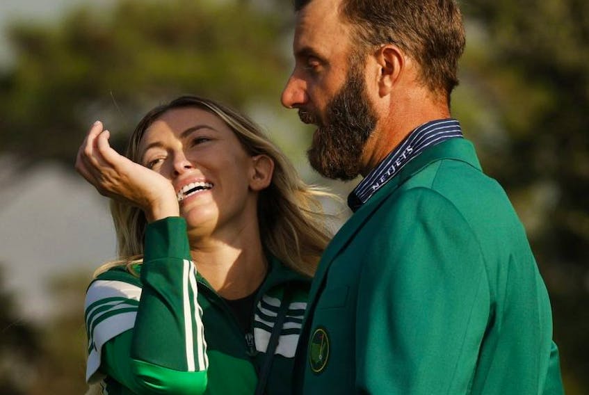 Dustin Johnson celebrates with partner Paulina Gretzky after winning The Masters. Reuters