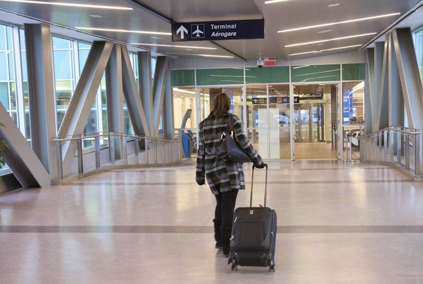 A passenger makes her way into the terminal at Halifax's Stanfield airport in 2017.