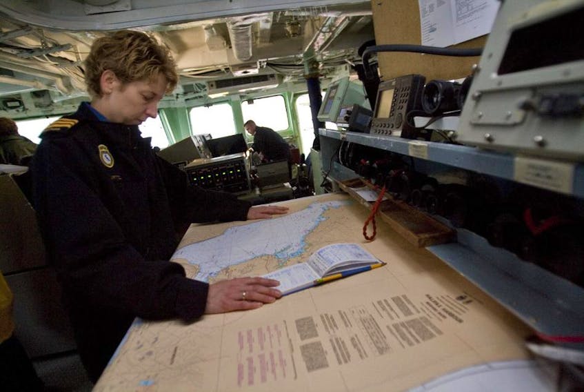 Commander Josée Kurtz looks over navigational charts on the bridge of the HMCS Halifax prior to an interview at HMC dockyards in Halifax Tuesday April 7, 2009 Commander Kurtz, assumed the command of the frigate HMCS Halifax on April 6, 2009 and is the first woman in the Canadian military to command a warship.