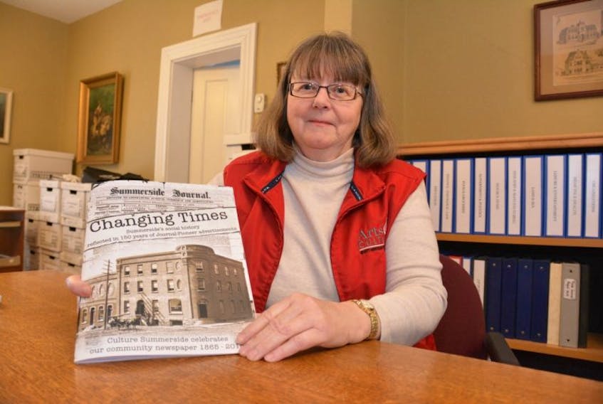 <p>Jean MacKay, an archivist with Culture Summerside, holds up a copy of “Changing Times: Summerside Social History reflected in 150 years of Journal Pioneer Advertisements.” The special booklet was printed to commemorate the paper’s anniversary year and has proved popular enough to get a second printing. Copies are available for free from the Journal Pioneer and Wyatt Heritage Properties.</p>