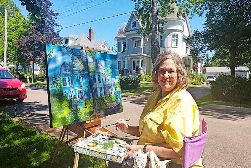 Joy Laking working on her painting as it nears completion on Monday. The artist was capturing the attention of passersby while painting 34 Rupert St.
