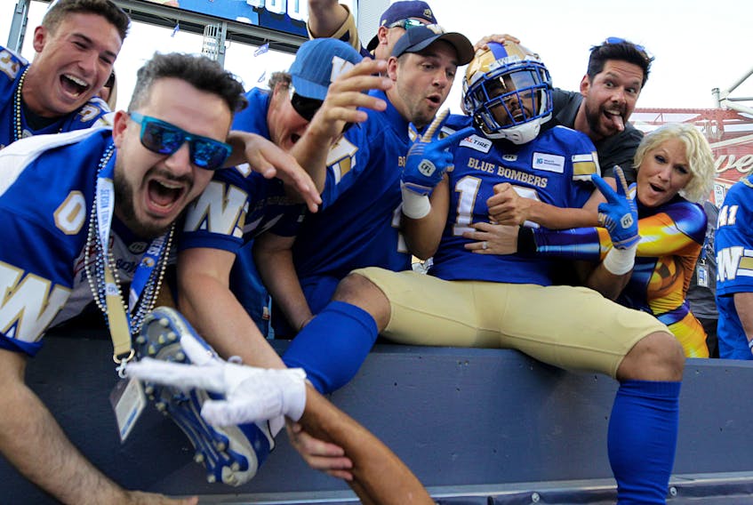 Winnipeg Blue Bombers receiver Nic Demski celebrates his touchdown catch against the B.C. Lions during CFL action with fans in the stands in Winnipeg on Thursday night. (KEVIN KING/WINNIPEG SUN)