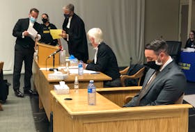 RNC Const. Doug Snelgrove (foreground) sits in the dock during the jury selection proceedings for his sexual assault trial in St. John's Tuesday, as his lawyers, Randy Piercey and Jon Noonan, chat with Crown prosecutor Lloyd Strickland.