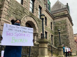 About a dozen people lined the sidewalk outside the Newfoundland and Labrador Supreme Court on Duckworth Street in St. John's Monday, while inside RNC Const. Doug Snelgrove was arraigned for a third time on a charge of sexual assault. The demonstrators called for judicial reform and an end to sexual violence, and expressed outrage and concern with the impact the court's handling of Snelgrove's case is having on sexual assault survivors in the community.