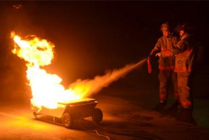 ['<p><strong>SAFE SWEEPING — </strong>Kyle Hart gets direction on how to use to a fire extinguisher from Addison Quilty, fire inspector with Gander Fire Rescue. Kyle is one of nine high school students participating in the junior firefighter program.</p>']