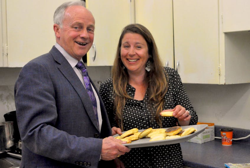 Sarah MacDonald is the Kings County coordinator for the Sharing Our Unappreciated Produce initiative, and stands with Minister of Communities, Culture and Heritage Leo Glavine who announced his department's funding of $50,000 for the initiative through the Building Vibrant Communities grant program on May 1.