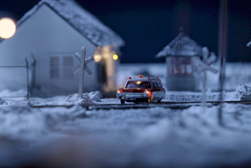 The train scene, which includes a car with battery-powered lights, was one of several tiny sets created by miniaturists Shelley Acker, Iris Sutherland, and their partner Kelly Pinheiro - who created this scene - for the Bernie Langille Wants to Know… Who Killed Bernie Langille documentary (photo credit: PEEP MEDIA).