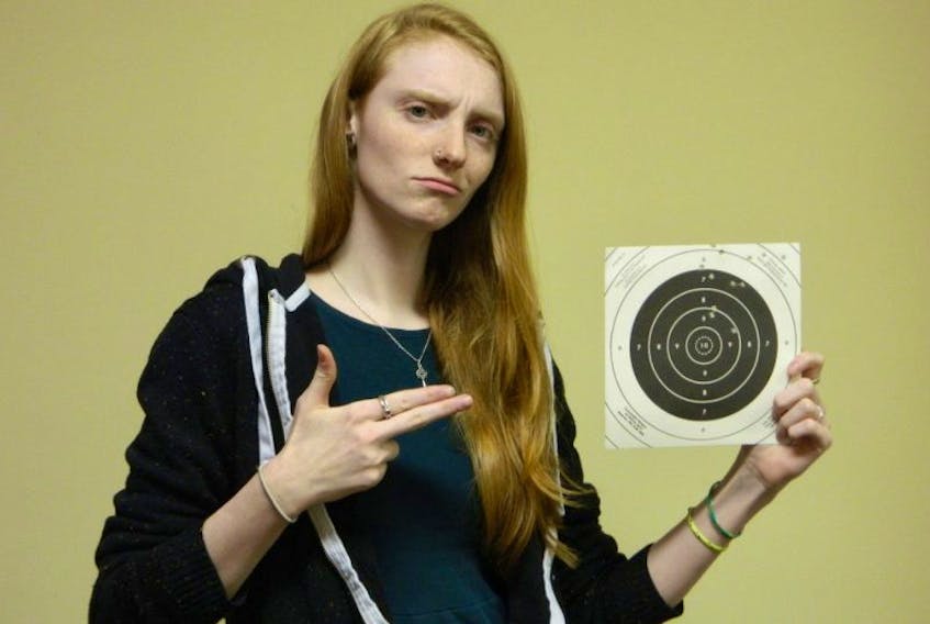 Student intern Teri Boates shows off her target after an outing with the Annapolis Valley Shooting Sports Club.
