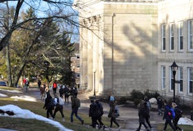 Students walking to class near the campus' University Hall building.