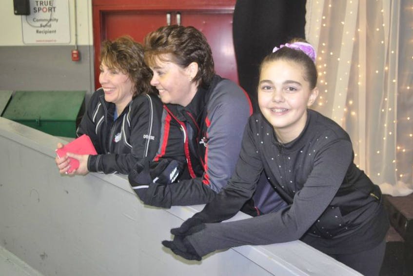 Jennika Graves smiles while her mother, Darlene Redden-Graves, centre, and another parent volunteer Denise Huntley Cameron watch the competition at the Fall Skate in Kentville.