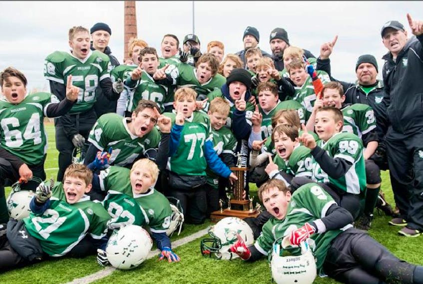 The Valley peewee Bulldogs celebrate with the championship trophy following their 51-0 win over Timberlea in the Football Nova Scotia Tier 1 championship Nov. 15 in Wolfville.