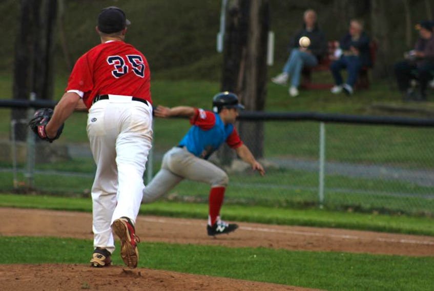 Starting pitcher Codey Shrider throws the ball at a Halifax player trying to steal second base