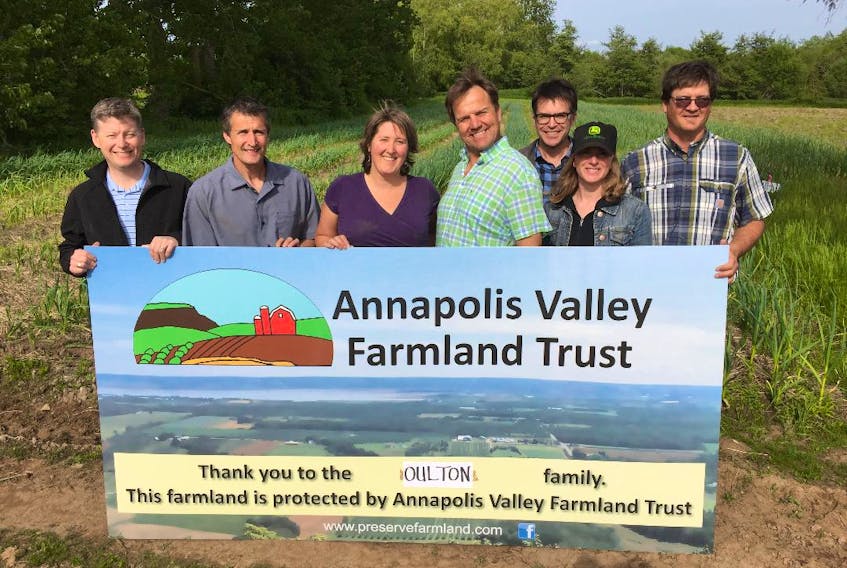 Annapolis Valley Farmland Trust members stand with Patricia Bishop and Josh Oulton, owners of TapRoot Farms, who donated 140 acres of their land to be kept in trust for future farming.