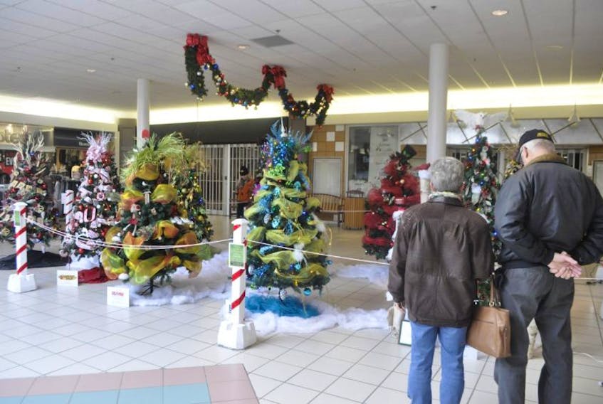 This couple stopped to view the 12 trees in the Festival of Trees fundraiser at the County Fair Mall in New Minas.