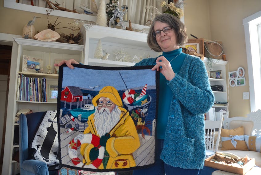 Hooked Rug Museum of North America Canadian Artist of the Year Janet Boates of Nicholsville with “Maritime Christmas”. Designed by her daughter, Angie Myers, the piece is among several by Boates that will be featured in the museum this year.