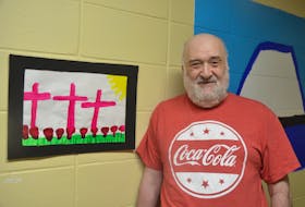 Kings Regional Rehabilitation Centre client Brenton Nauss with his Remembrance Day-inspired painting that was on display as part of a show featuring the artistic creations of centre clients.