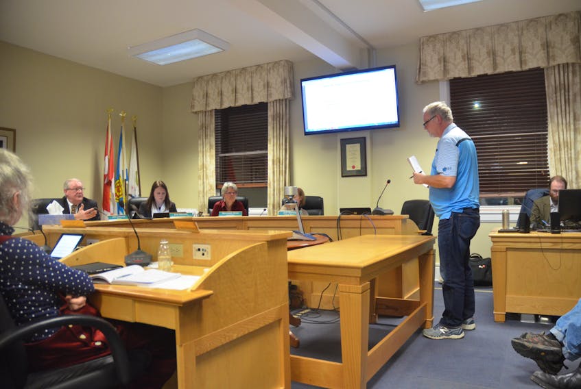 Wolfville Mayor Jeff Cantwell and concerned resident Glenn Howe exchange words over proposed amendments that would enable off-site sales for microbreweries in town, including the recently established Church Brewing Company.