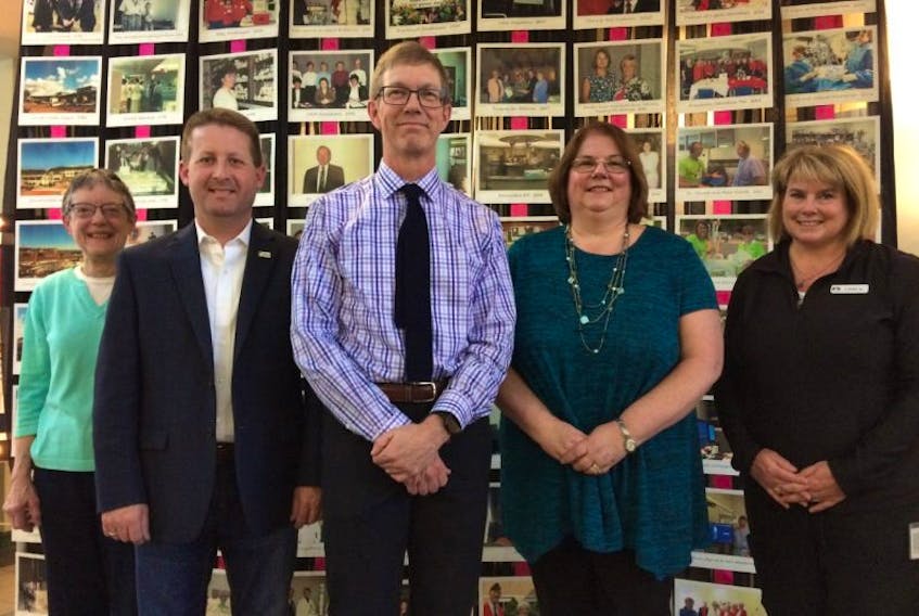 Pat Foote, David Hovell, Dr. Michael Dunn, Karen Jenkins and Cathy Hale stand by a photo display commemorating the 25th anniversary of the Valley Regional Hospital.