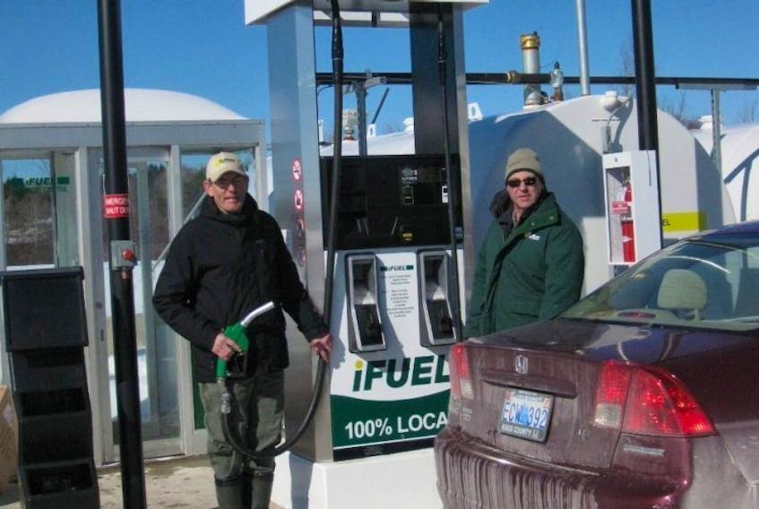 This March 2014 photo shows Jon Oulton, left, and Canning resident Terry Porter when the new gas bar opened. Now changes are happening.