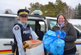 Kings District RCMP community policing officer Const. Kelli Gaudet and Kings County Seniors Safety co-ordinator Michelle Parker collecting documents at a Community Shred-It event in New Minas on March 12.