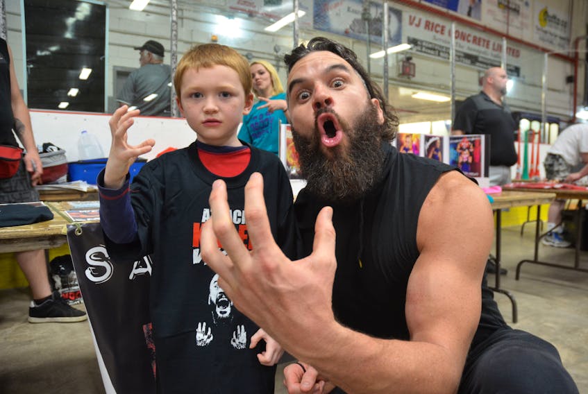 Former UCW champion Markus Burke poses with one of his many fans at a UCW show in Kentville in July 2016. Burke is among the stars returning to Kentville for the April 28 UCW show.