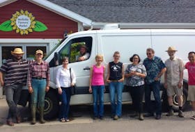 Vendors at the Wolfville Farmers Market stand in front of the new van for deliveries starting next month to three community hubs.
