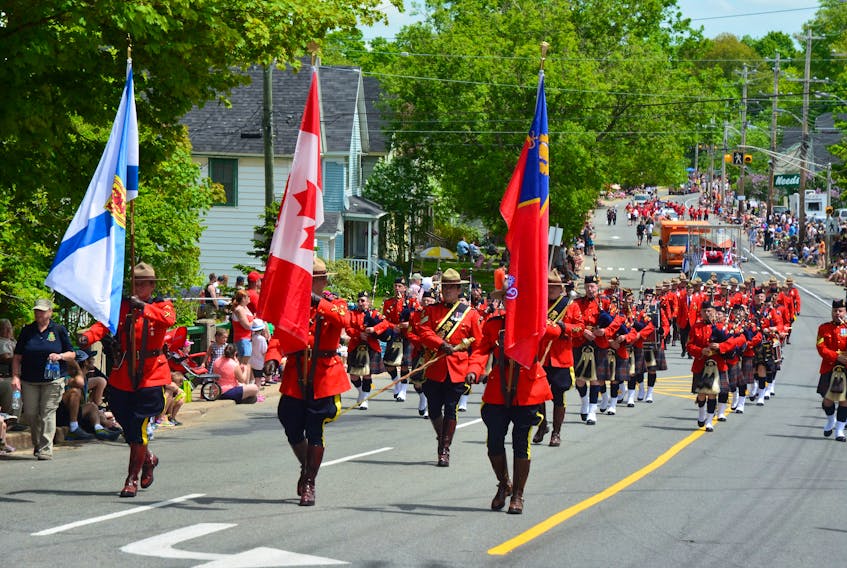 The Royal Canadian Mounted Police display the red serge at the 2015 Apple Blossom Festival Grand Street Parade.