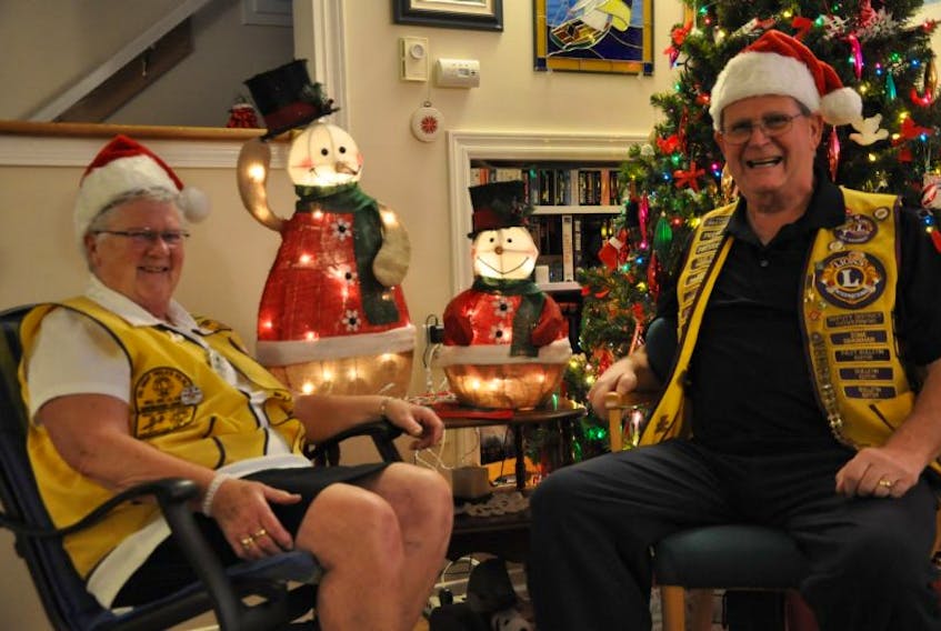 Kingston Lions Club members Barb and Bob Lyle sit by a couple of snowman door prizes Steve Morse Towing donated for the upcoming Christmas Mommies and Daddies telethon in Aylesford Nov. 27.