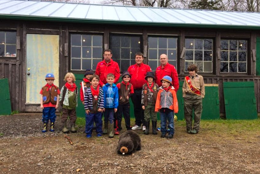Some of the First Wolfville Beavers, their leaders, and a helper cub proudly show off the new metal roof on the E. Percy Brown Lodge at the Sunken Lake Scout Camp. Barnett Builders of Greenwich donated the roof.