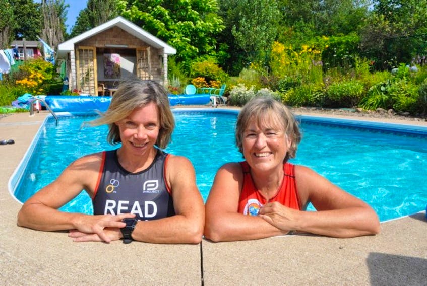 Coach Shannon Read, left, and Masters level athlete Anne Murray cool off in Murray’s New Minas pool one sunny day recently.