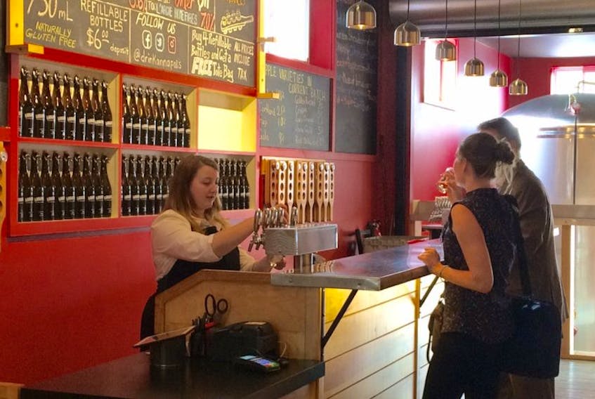 Customers stop at the Annapolis Cider bar and taste some of the offerings.