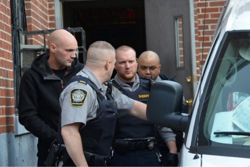Leif Spilchen, far left, is pictured being escorted out of the courthouse in Windsor. - Colin Chisholm