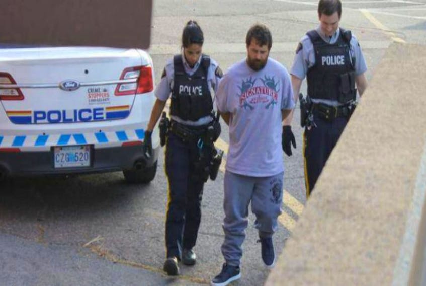 Nikolas Derrick Salsman, 30, of New Minas, is led into the provincial courthouse in Kentville on Sept. 25. He's charged with second-degree murder in the death of 34-year-old Trevor Allen Joseph Pelton of New Minas. - File photo