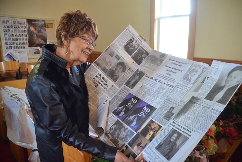 Gibson Woods United Baptist Church deacon and clerk Geraldine Browning looks at an information display featuring several projects and initiatives that members of the Gibson Woods United Baptist Church Ladies Auxiliary have been involved with over the years.