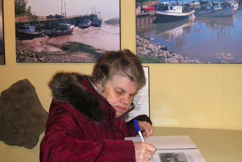 Linda Hart signs a copy of her new book.
