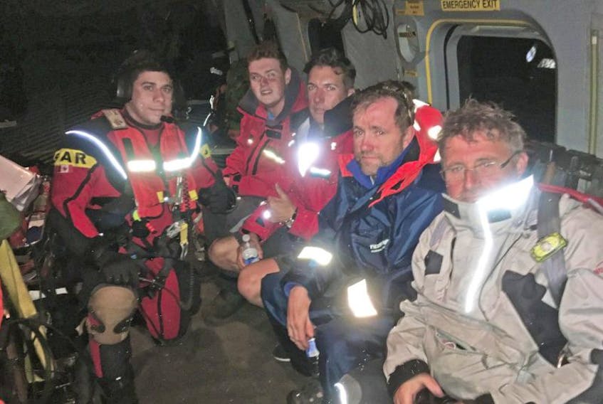 Safely aboard a 413 (Transport and Rescue) Squadron Cormorant early May 27, the crew of the lost schooner Sorca with SAR-Tech Master Corporal Ryan Morris.